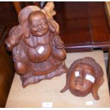 A carved hardwood Buddha together with a hardwood