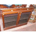 A Regency rosewood bookcase with brass grill doors