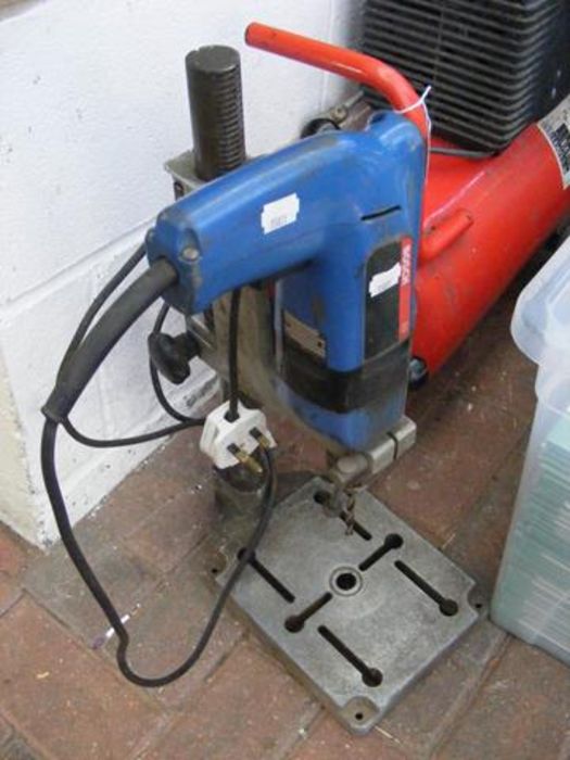 A Bosch drill on stand