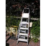Two aluminium ladders, a workmate and sack trucks