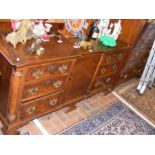 A Georgian oak sideboard with centre cupboard flan