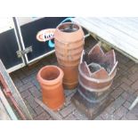 Three chimney pots of varying shapes and size