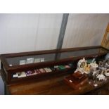 An antique mahogany narrow display cabinet