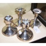 A pair of silver candlesticks and one other pair