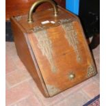 An antique wooden and brass bound coal scuttle