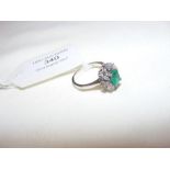 An emerald and diamond ring in 18ct white gold set