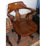 An antique curved back office swivel chair