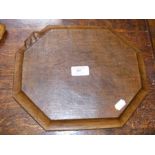 A carved Mouseman cheeseboard of octagonal form -