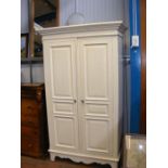 A two door white painted wardrobe