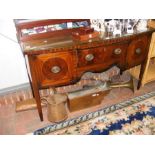 An antique bow front sideboard