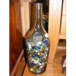 A large glass bottle full of marbles