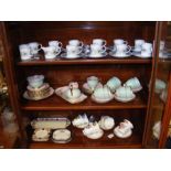 Three shelves of tea ware, including Royale Stratf