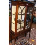 An Edwardian two door display cabinet with drawers