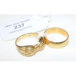 An 18ct gold wedding band together with one other