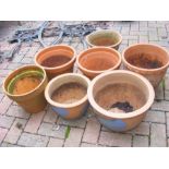 Seven terracotta garden planters of varying size