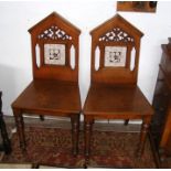 A pair of 19th century Gothic style hall chairs wi