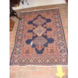 An antique Middle Eastern carpet with geometric bo