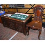 An antique coffer with carved panelled front, toge