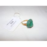An emerald cluster ring - the centre emerald appro