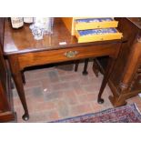 An antique mahogany side table with single drawer