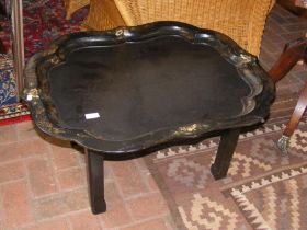 A Victorian papier mache serving tray on later sta