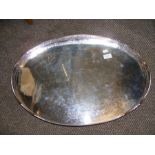 A large silver plated two handled serving tray with pierced rim