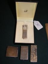 A vintage Dunhill lighter together with three others