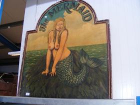 A reproduction mermaid advertising sign
