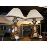 A pair of decorative gilt and sevres style table lamps - 34cms high