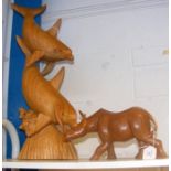 A carved wooden rhino and dolphin pair