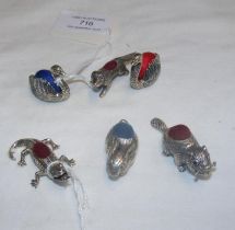 Six silver pin cushions including two swans, dog etc.