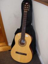 A six string acoustic guitar in soft case