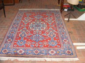 A Middle Eastern rug with geometric border and cen