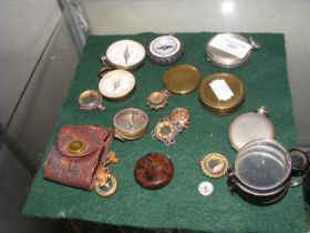 Various miniature pocket and pendant compasses