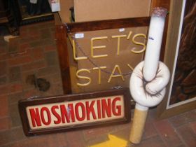 'Let's Stay Home' neon sign, 'No Smoking' sign and