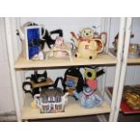 A quantity of novelty teapots - on two shelves