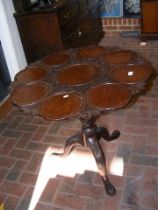 An antique mahogany tripod table with birdcage mov