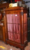 A 19th century Biedermeier cabinet with glazed doo