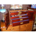 An antique five drawer part canteen of cutlery wit