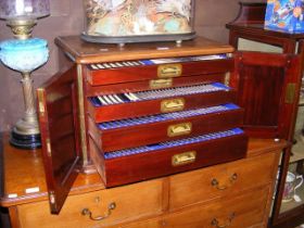 An antique five drawer part canteen of cutlery wit