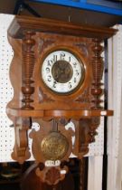 An antique wall clock with striking movement and v