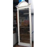 An antique tall hall mirror with white painted sur