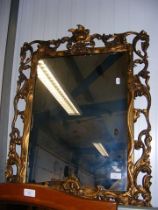 An ornate gilt framed wall mirror