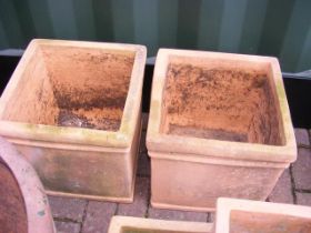 A pair of square terracotta plant pots