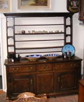 A Georgian oak dresser with plate rack over, drawe