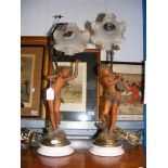 A pair of decorative cherub table lamps