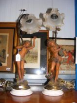 A pair of decorative cherub table lamps