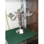 A 24cm high silver three branch candelabra with gl