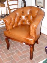 A button back brown leather easy chair on cabriole