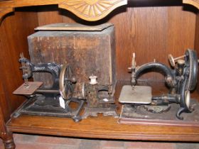 A miniature sewing machine together with Singer an